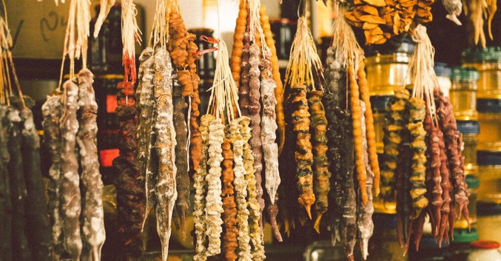 Close-up of colorful traditional Georgian churchkhela sweets hanging in a market.