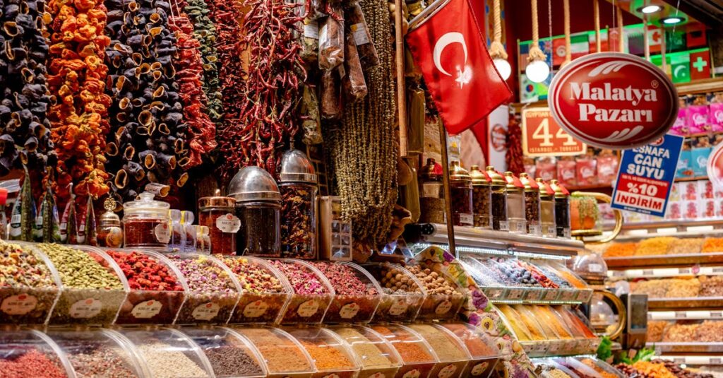 Colorful display of spices and dried goods at a Turkish market stall showcasing local commerce in an indoor bazaar.