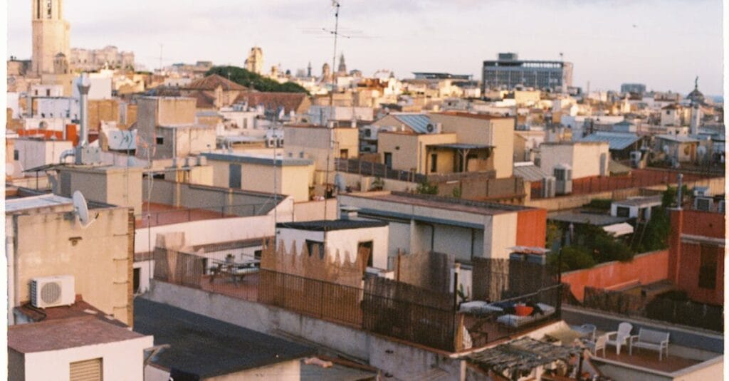 A captivating aerial shot of Barcelona's diverse rooftops showcasing urban architecture at twilight.