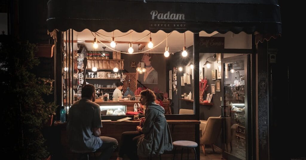 Charming night scene at Padam Coffee Shop with people enjoying a warm atmosphere in Ankara, Turkey.