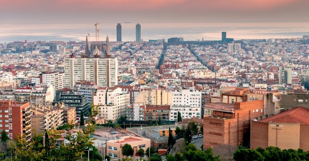 Stunning aerial view of Barcelona's vibrant cityscape during sunset.