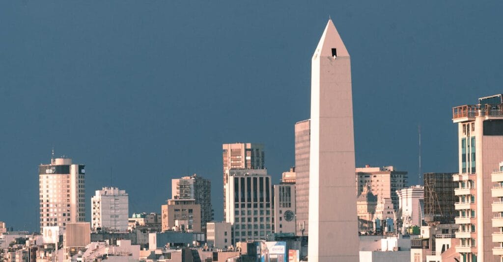 A stunning aerial view of Buenos Aires showcasing the iconic Obelisco surrounded by city skyscrapers.