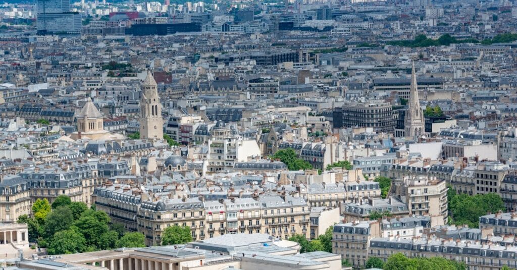 Stunning aerial view of Paris showcasing historic architecture and skyline on a clear day.