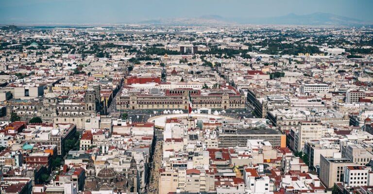 Aerial view capturing the sprawling urban landscape of Mexico City with historic architecture.
