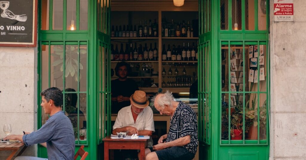 Elderly men enjoying drinks at a cozy Lisbon wine bar. Perfect street ambience.
