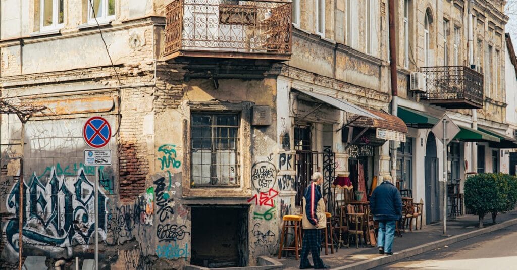 Eclectic street corner in T'bilisi, Georgia, with graffiti and architectural charm.