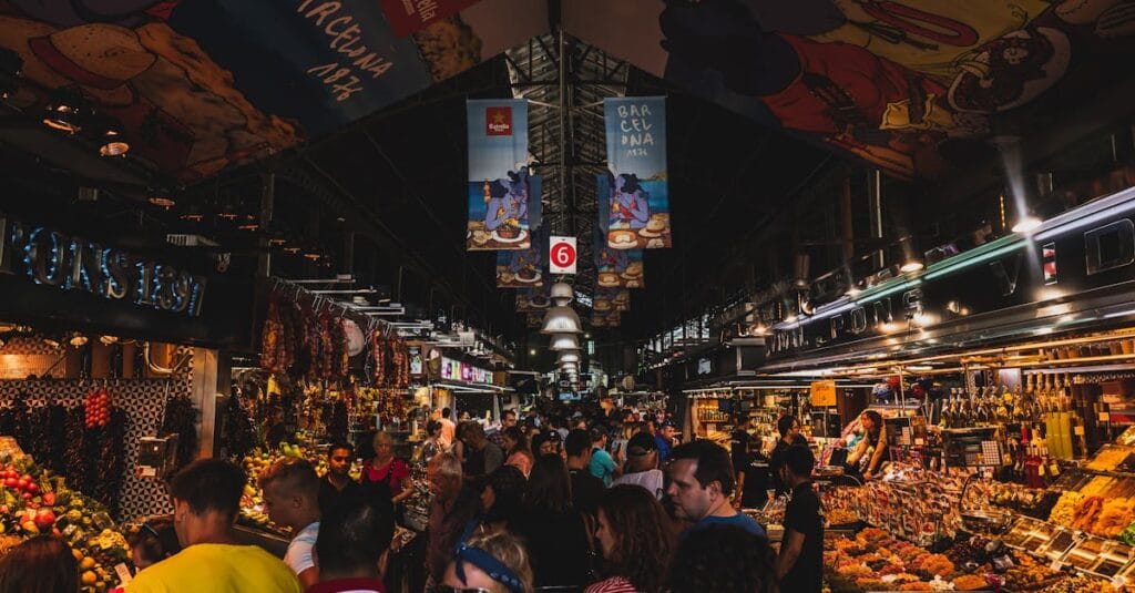 Vibrant and bustling scene from a crowded market in Barcelona, Spain showcasing lively shopping and diverse foods.