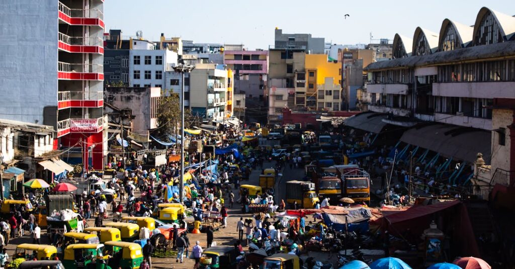 Bustling street scene in Bengaluru, India with colorful vehicles and vibrant market activity.