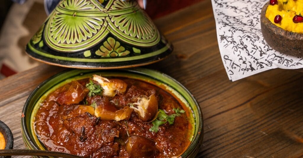 Vibrant Moroccan meal with tagine, couscous, and colorful sides, highlighting cultural richness.