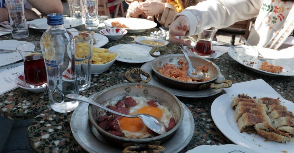A vibrant Turkish breakfast scene with diverse dishes and tea in a cozy İstanbul café.