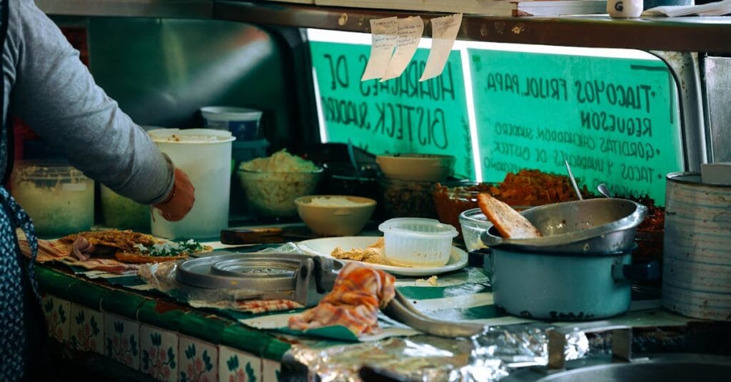 A bustling street food vendor preparing traditional Mexican dishes in Mexico City.
