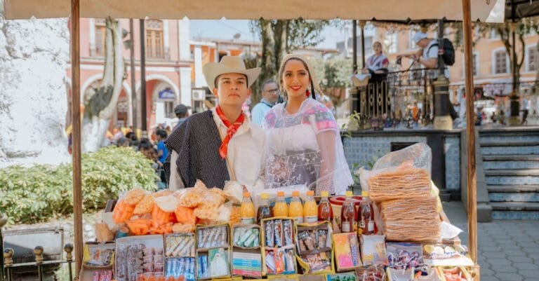 Vibrant street vendors selling traditional sweets in Huauchinango, Mexico market.