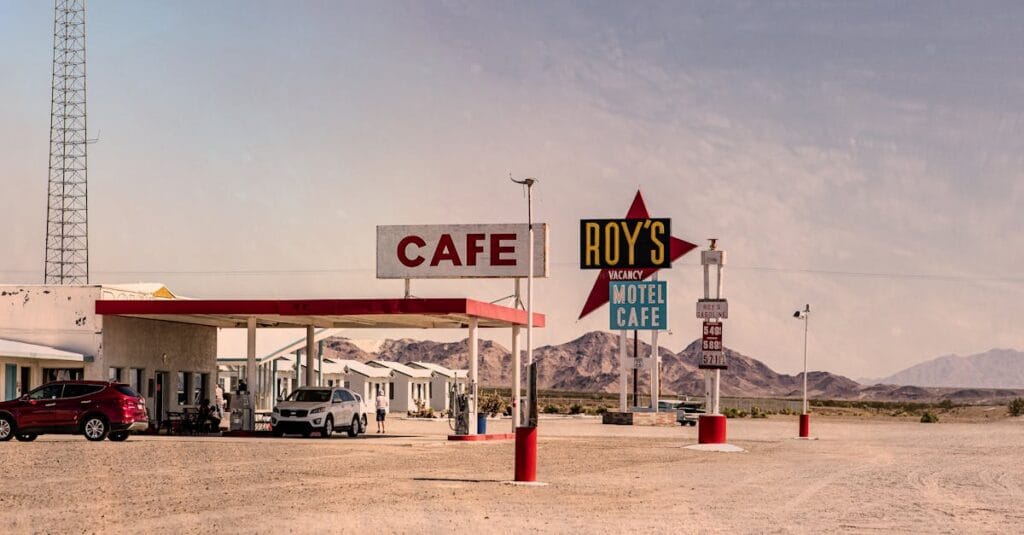 A classic view of Roy's Motel and Cafe in the desert with vintage signs and barren surroundings.