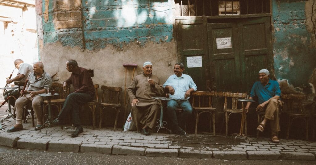 Local men enjoy a casual gathering outside a café in Cairo's historic Al-Darb Al-Ahmar district.