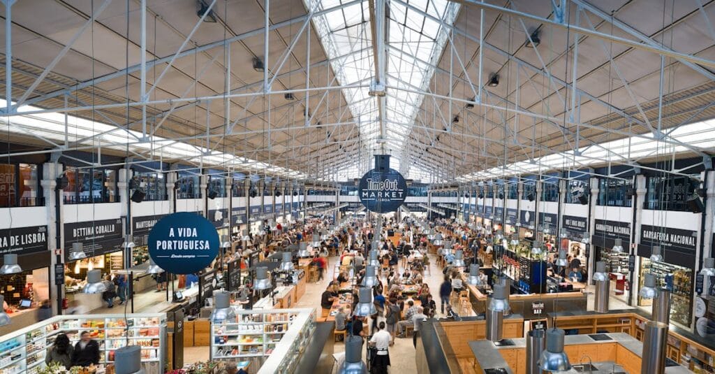 Vibrant view of Lisbon's Time Out Market featuring diverse food stalls and visitors.
