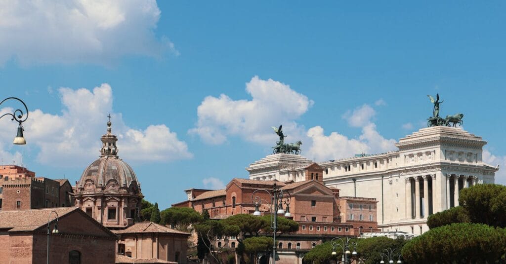Experience the classic beauty of Rome's iconic buildings against a clear blue sky.