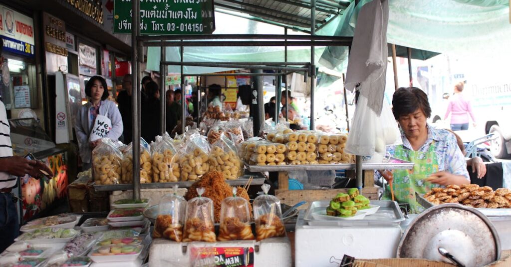 Explore the vibrant street market in Bangkok with diverse Thai food stalls offering traditional cuisine.