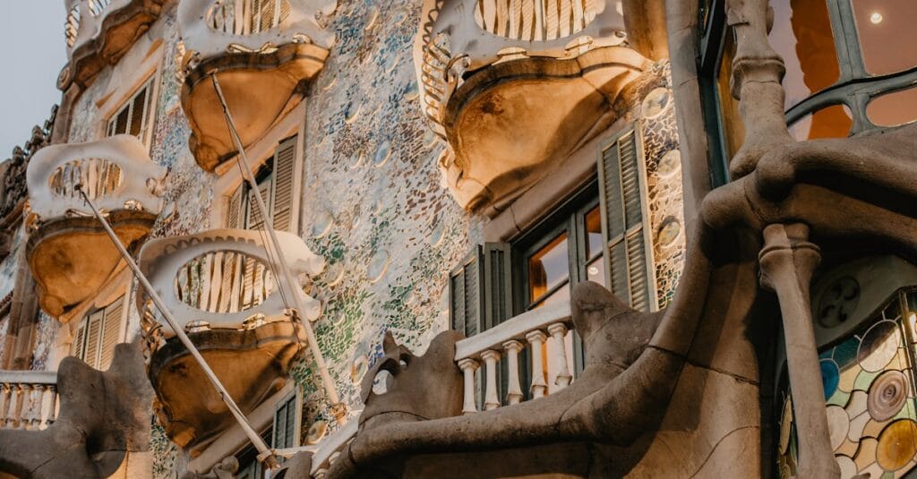 A detailed view of Casa Batlló's unique Gaudí design facade in Barcelona at dusk.