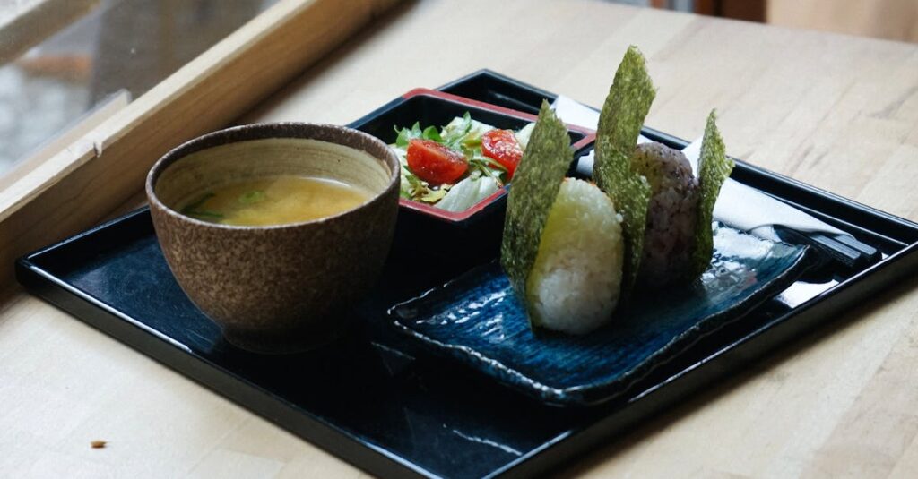 Delicious Japanese meal with onigiri, miso soup, and salad served indoors in Berlin.