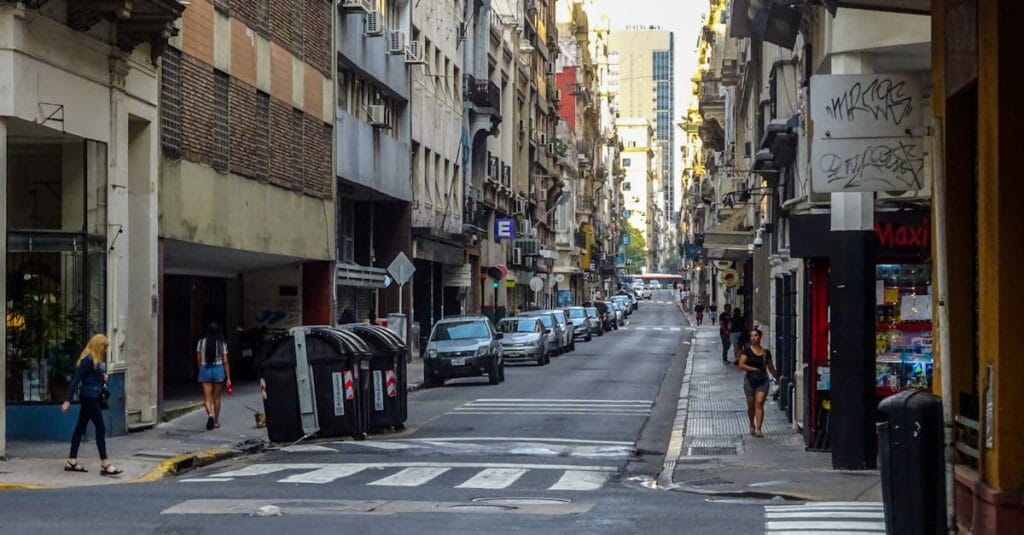 Busy street in Buenos Aires showing everyday city life with pedestrians and vehicles.