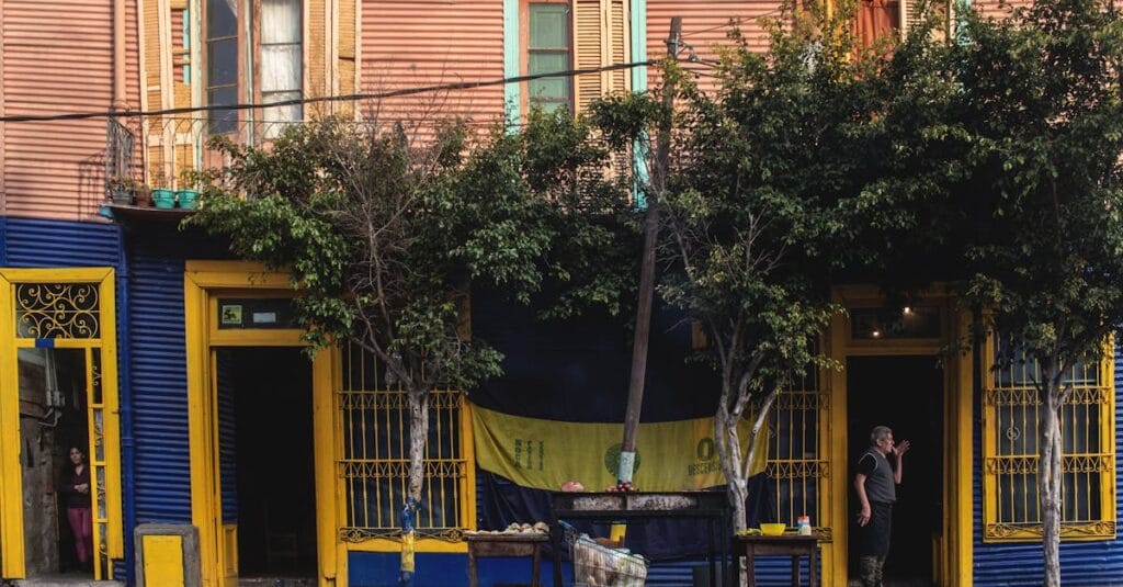 Vibrant street scene of La Boca neighborhood in Buenos Aires, showcasing colorful architecture and local life.
