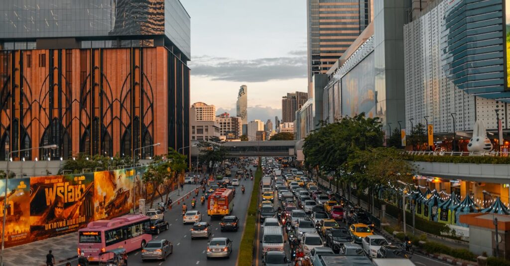 Vibrant cityscape of Bangkok at dusk with bustling traffic and skyline in view.