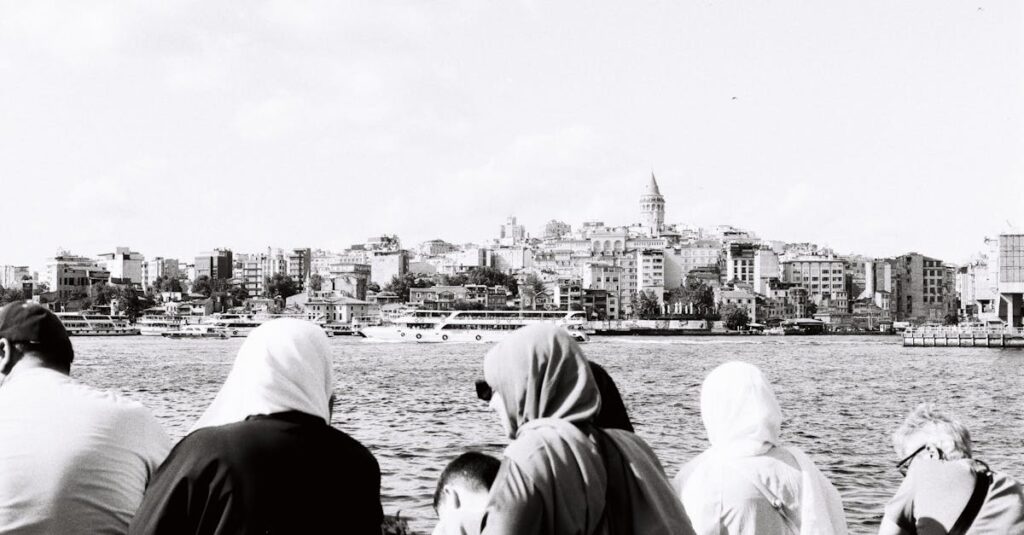 Scenic view of İstanbul's skyline featuring Galata Tower over the water in black and white.