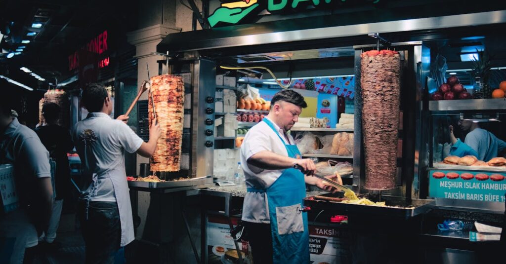 Delicious Turkish doner kebabs being prepared at a vibrant night street food stall in Istanbul.