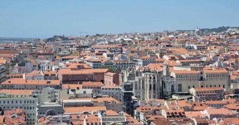 Discover the stunning aerial view of Lisbon's iconic orange rooftops and historic architecture.