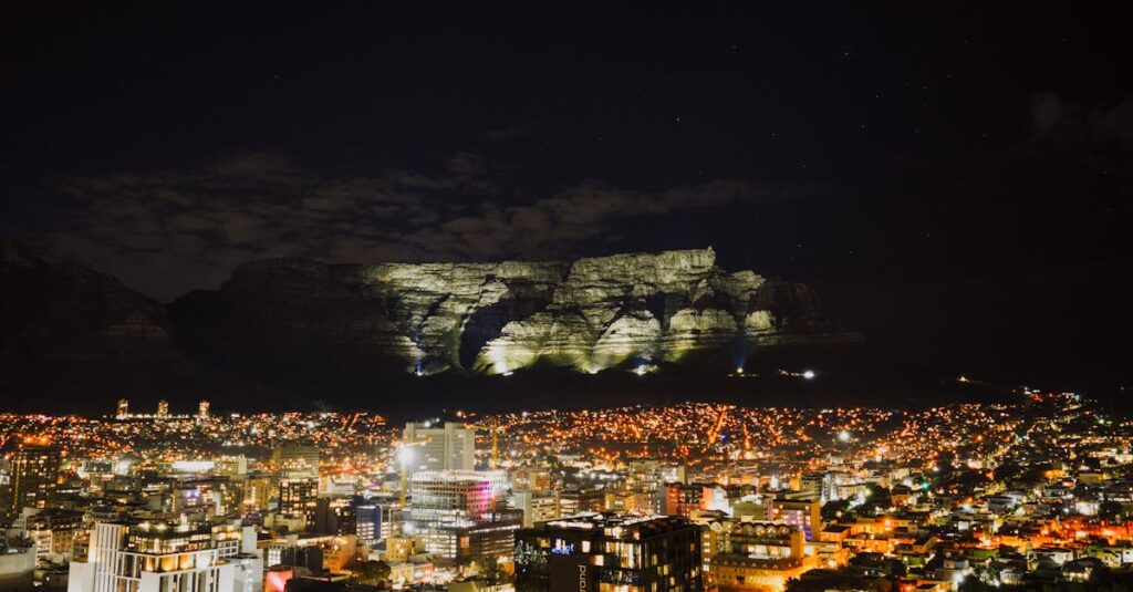 A breathtaking night cityscape of Cape Town, featuring the illuminated Table Mountain as a striking backdrop.