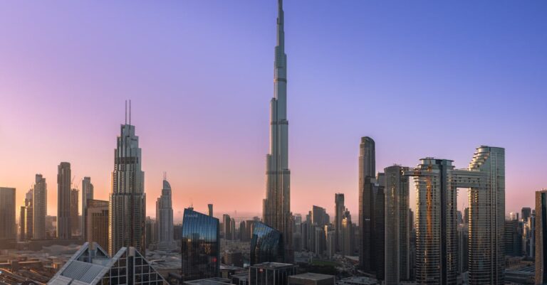 The iconic Burj Khalifa rises majestically over Dubai's modern skyline at sunrise.