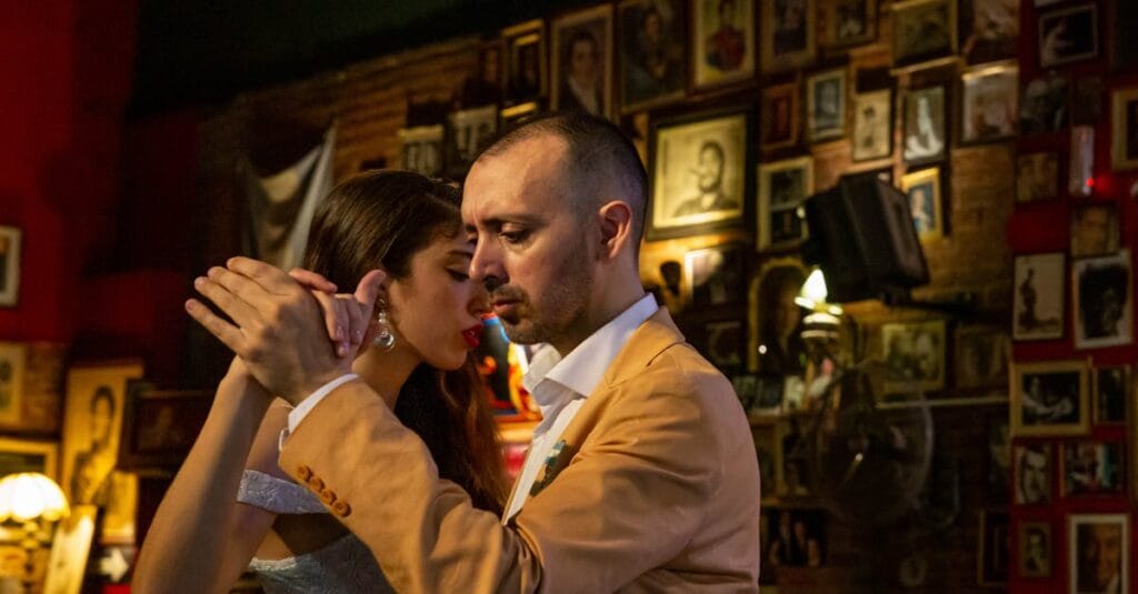 A couple deeply engaged in a passionate tango dance in a cozy bar in Mar del Plata, Argentina.
