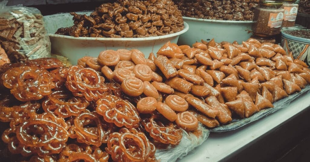 A variety of traditional Moroccan sweets displayed at a market in Fes, Morocco, showcasing local culinary culture.