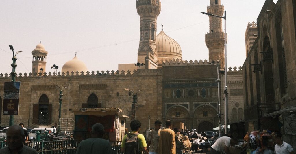 Street market scene near a historic mosque in Cairo, showcasing Egyptian architecture and local vendors.