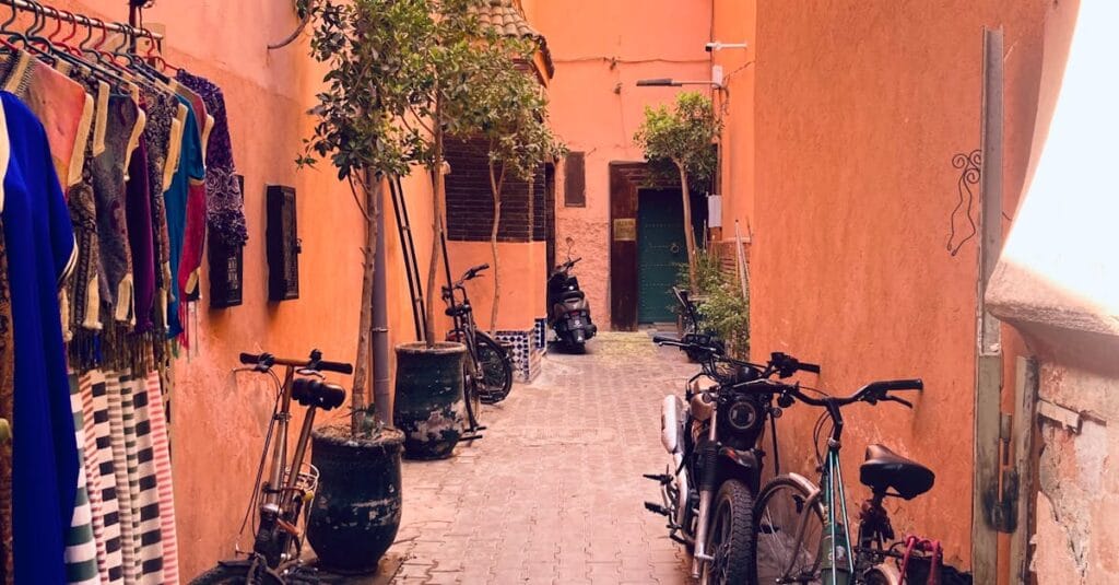Picturesque alleyway with bicycles and colorful textiles in Marrakech.