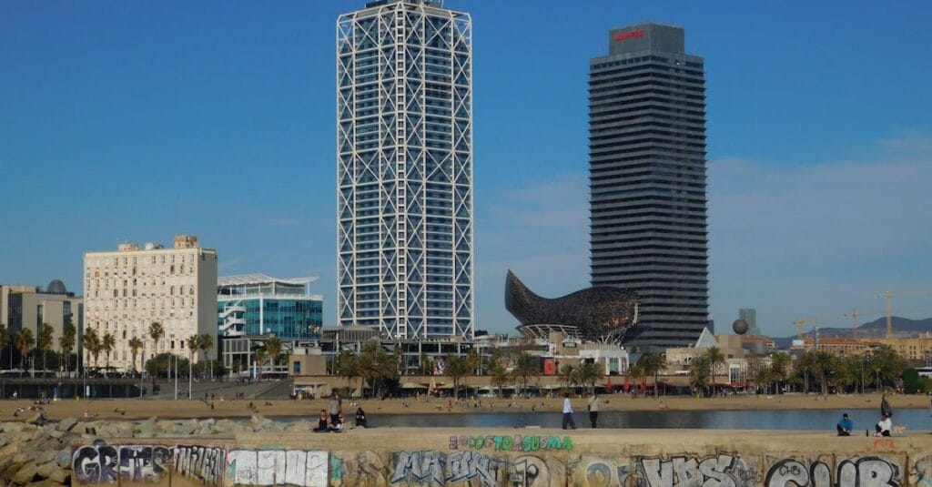Stunning view of Barcelona's skyline featuring W Barcelona Hotel and Barceloneta Beach.