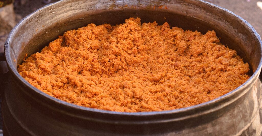 Large pot of Jollof rice cooking outdoors in Jos, Nigeria, with vibrant cultural elements.