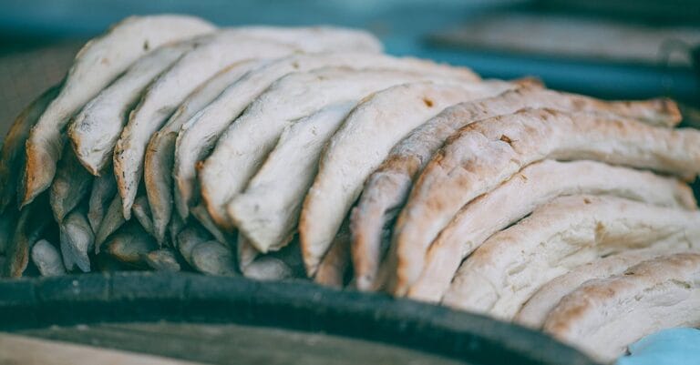 High angle of fresh delicious baked traditional Georgian shoti bread in heap in bakery