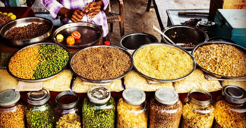 Colorful display of spices and legumes in a traditional Indian street market.