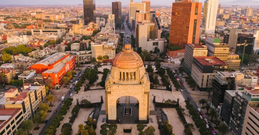 Stunning aerial view of Mexico City's Monumento a la Revolución surrounded by cityscape.